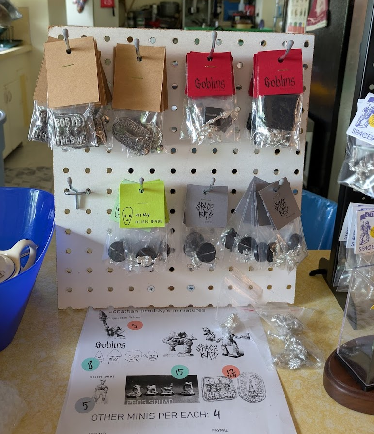 a small pegboard with a bunch of minis hanging from it