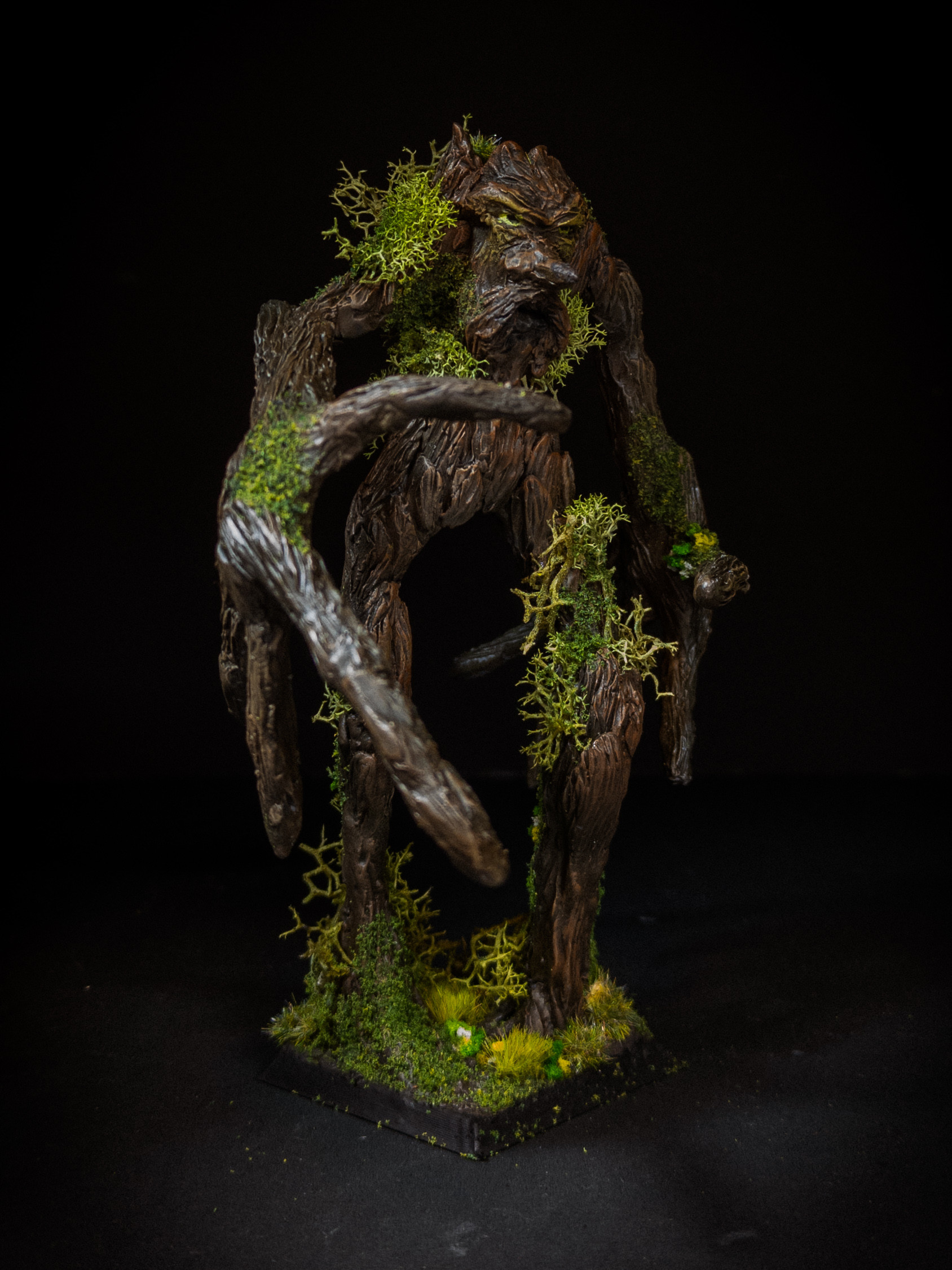 Mossy ent striding towards the camera. It has a giant hand