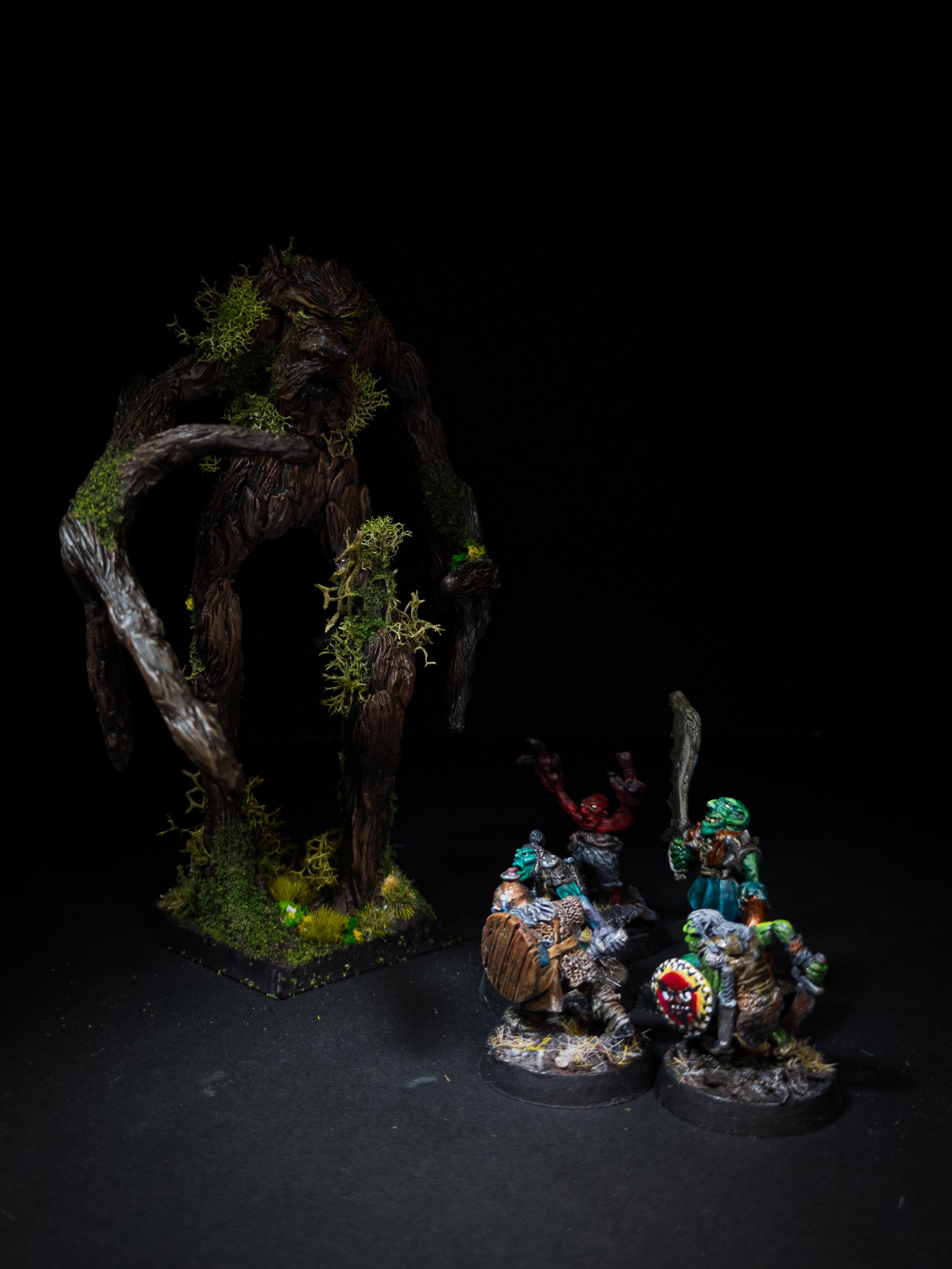 Mossy ent being threatened by a group of goblins