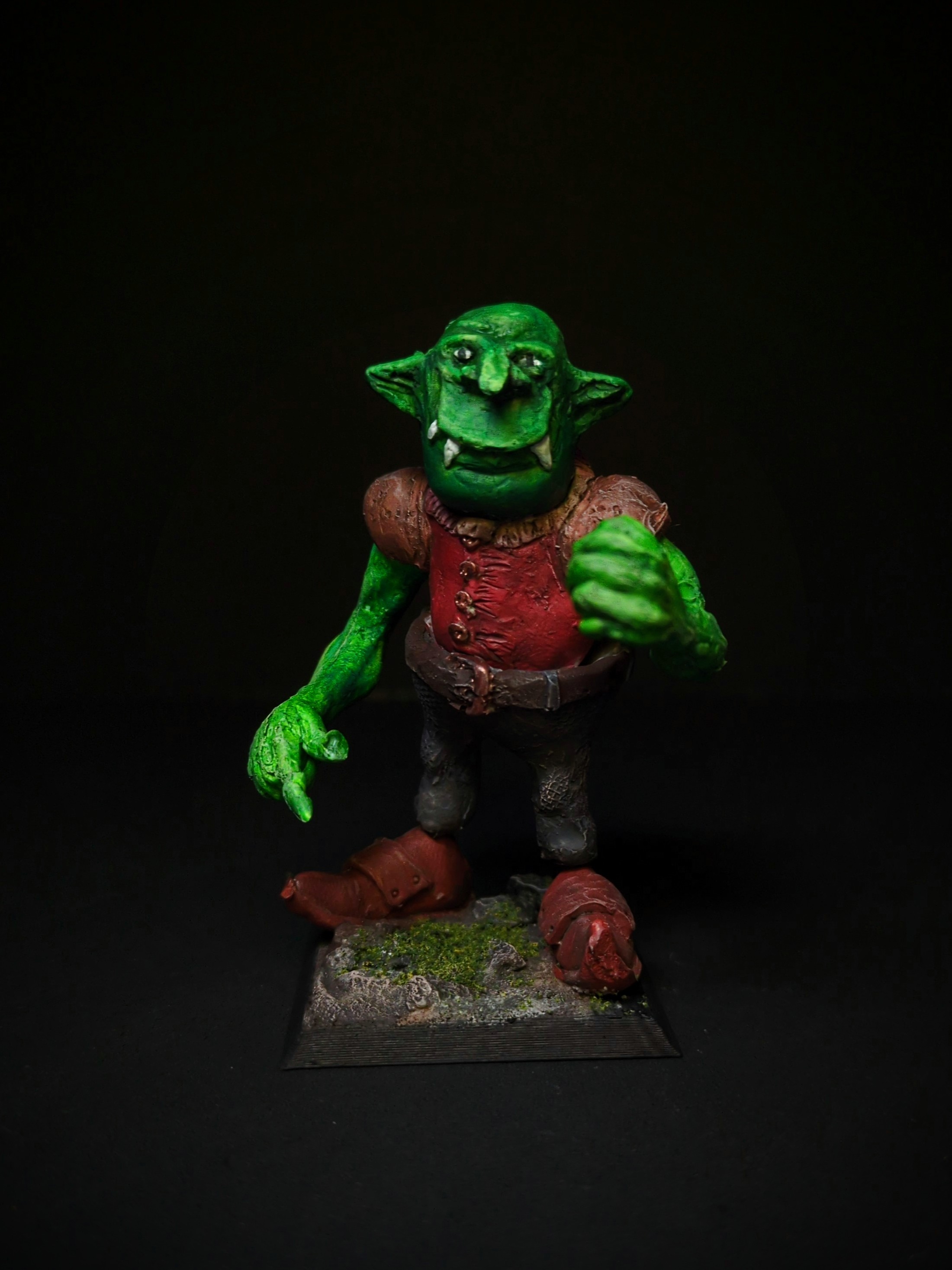 Big painted goblin threatening with raised fist